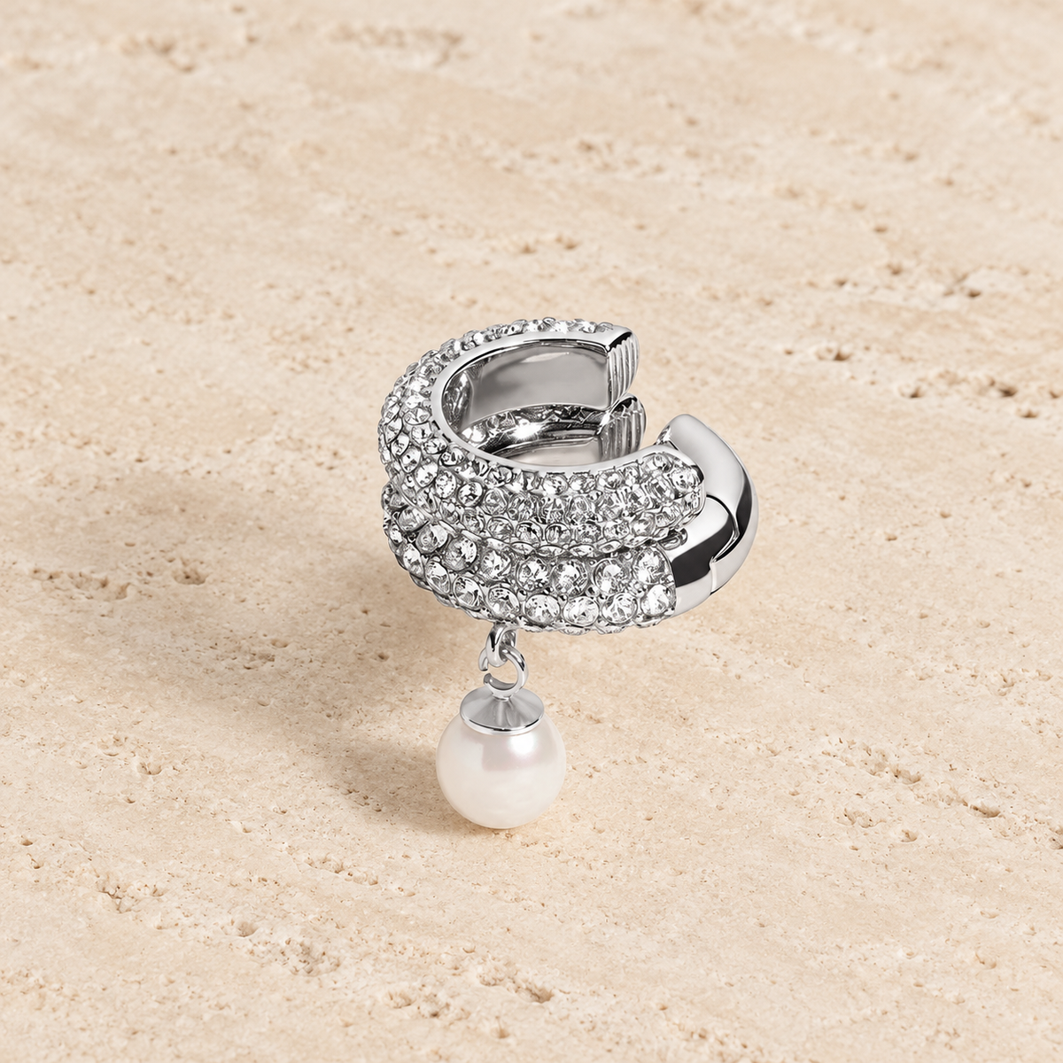 Pearl Crystal Ear Cuff — pale beige natural stone background