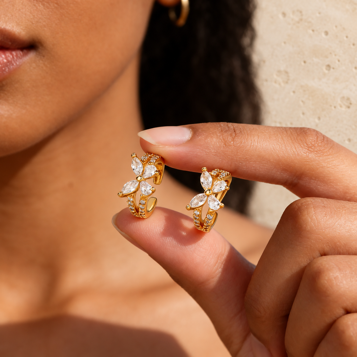 Crystal Butterfly Ear Cuff — pale beige natural stone background