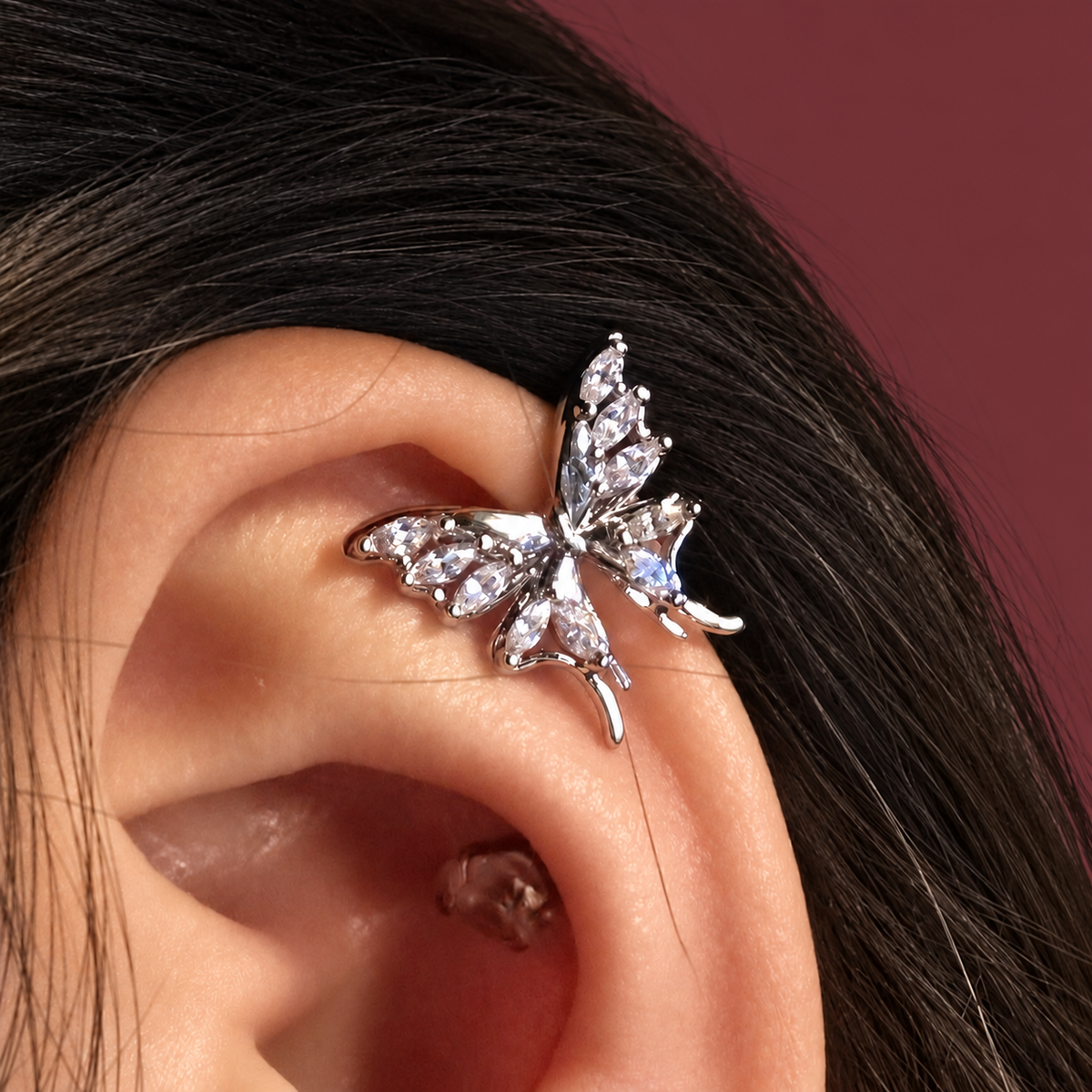 Gold-Tone Butterfly Ear Clip — muted burgundy background