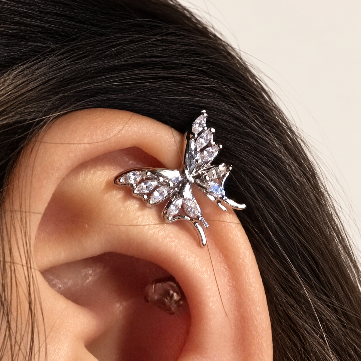 Gold Butterfly Ear Clip — warm ivory background