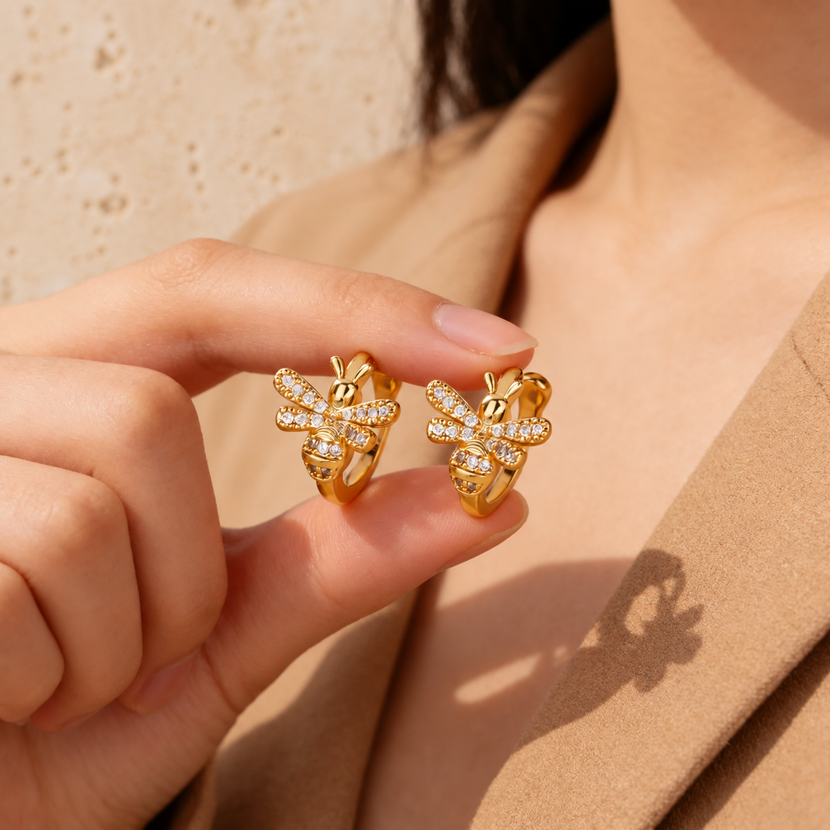 Crystal Bee Ear Cuff — pale beige natural stone background