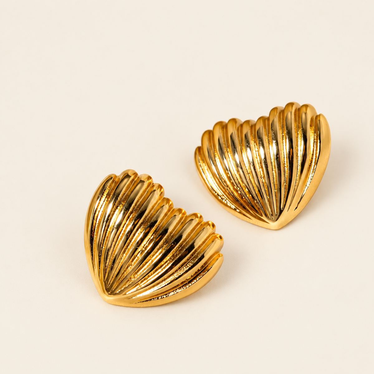 Gold Shell Studs — warm ivory background