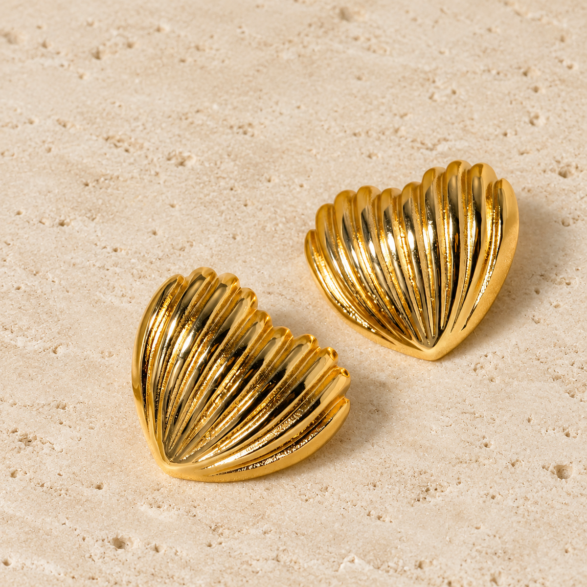 Gold Shell Studs — pale beige natural stone background