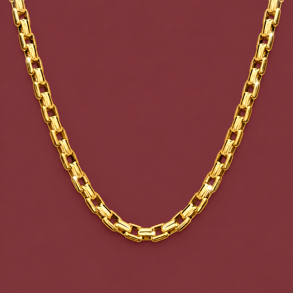 Gold-Tone Box Chain — muted burgundy background