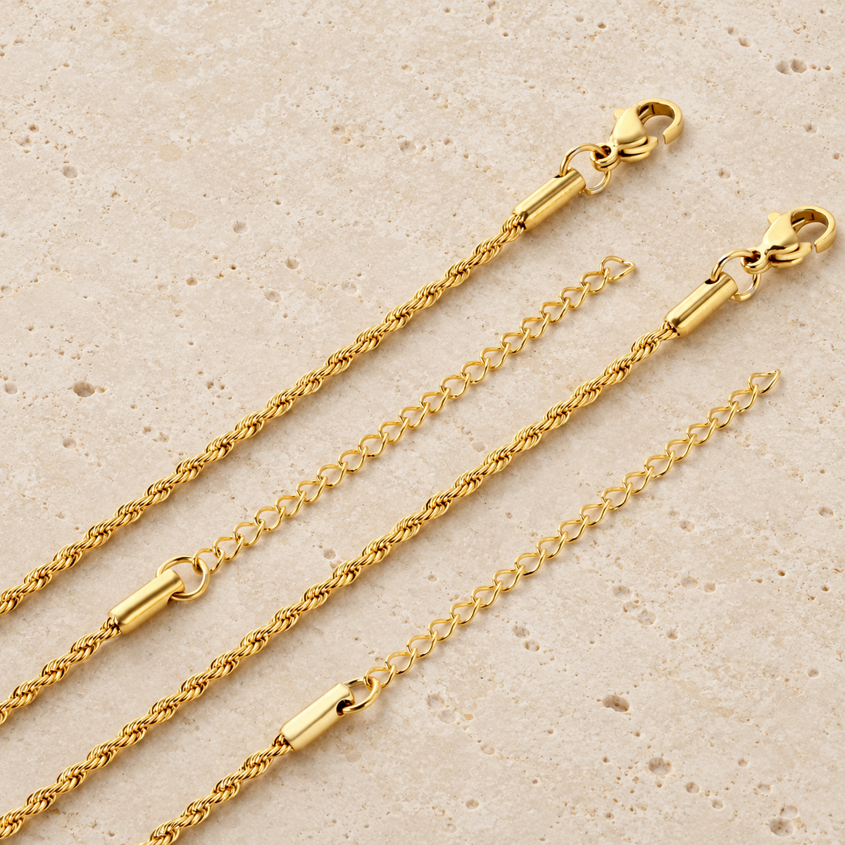 Slim Gold Rope Chain — pale beige natural stone background