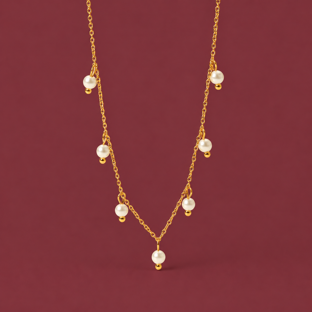 Pearl Charm Necklace — muted burgundy background