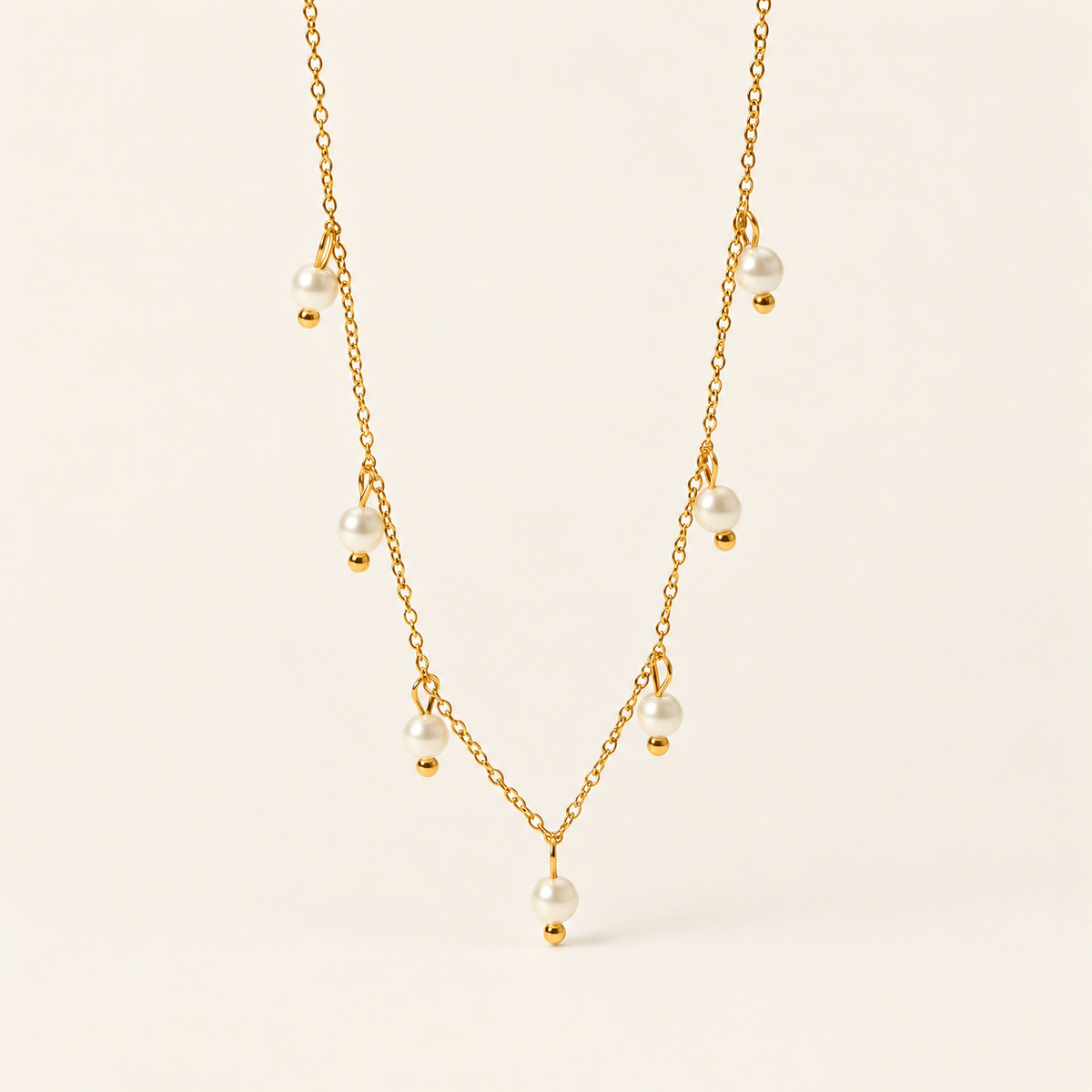 Pearl Charm Necklace — warm ivory background