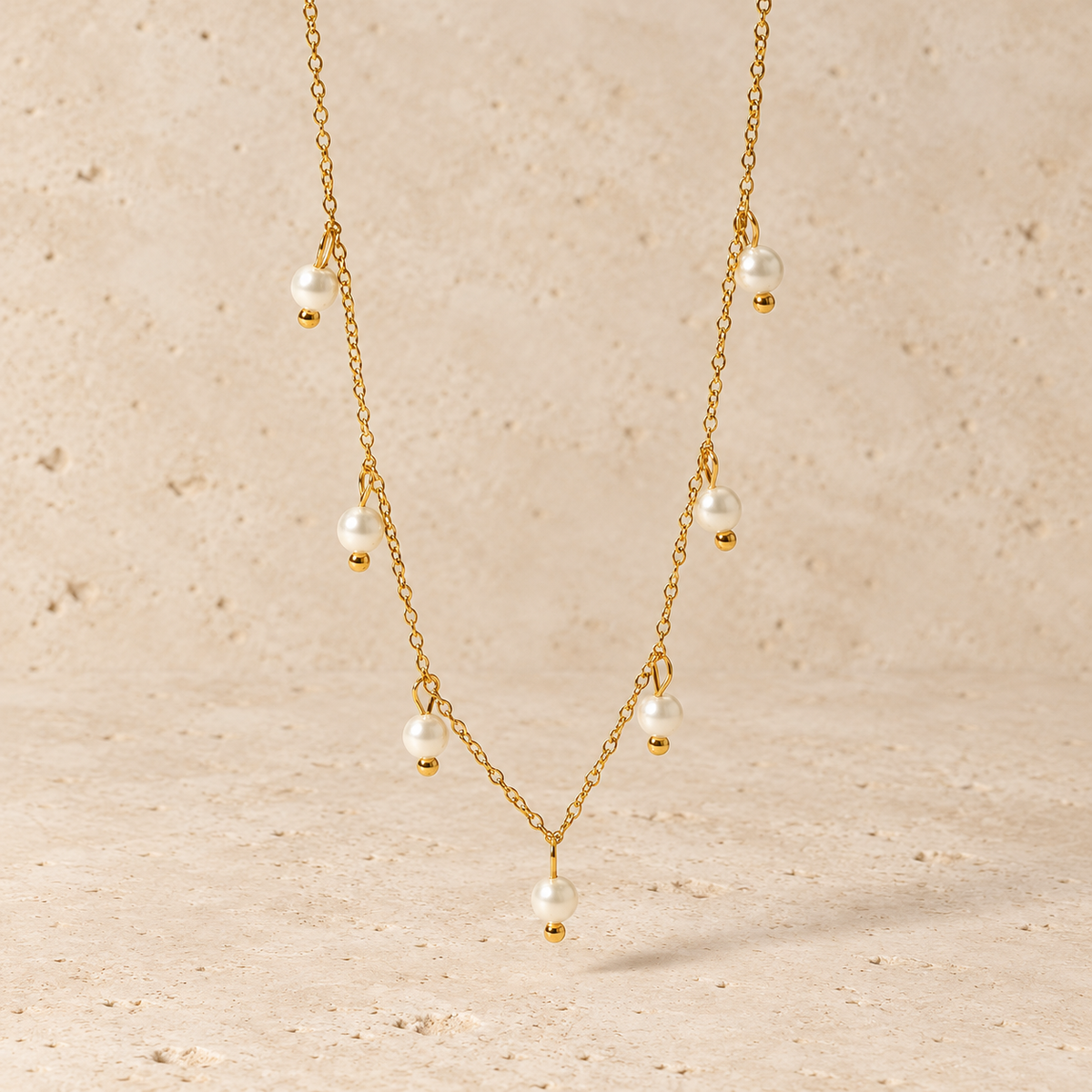 Pearl Charm Necklace — pale beige natural stone background