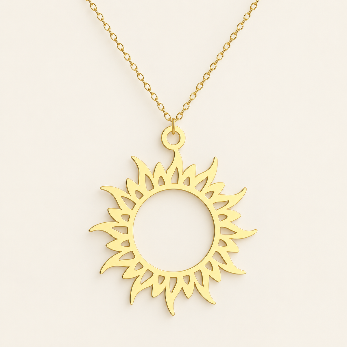 Gold Sun Symbol Necklace — warm ivory background
