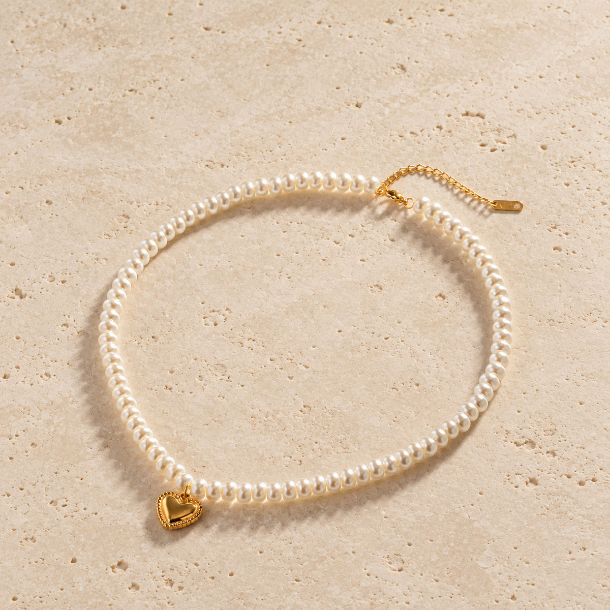 Pearl Love Pendant Necklace — pale beige natural stone background