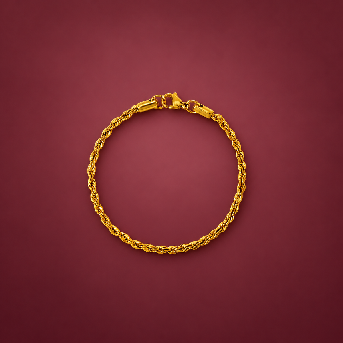 Gold-Tone Rope Bracelet — muted burgundy background