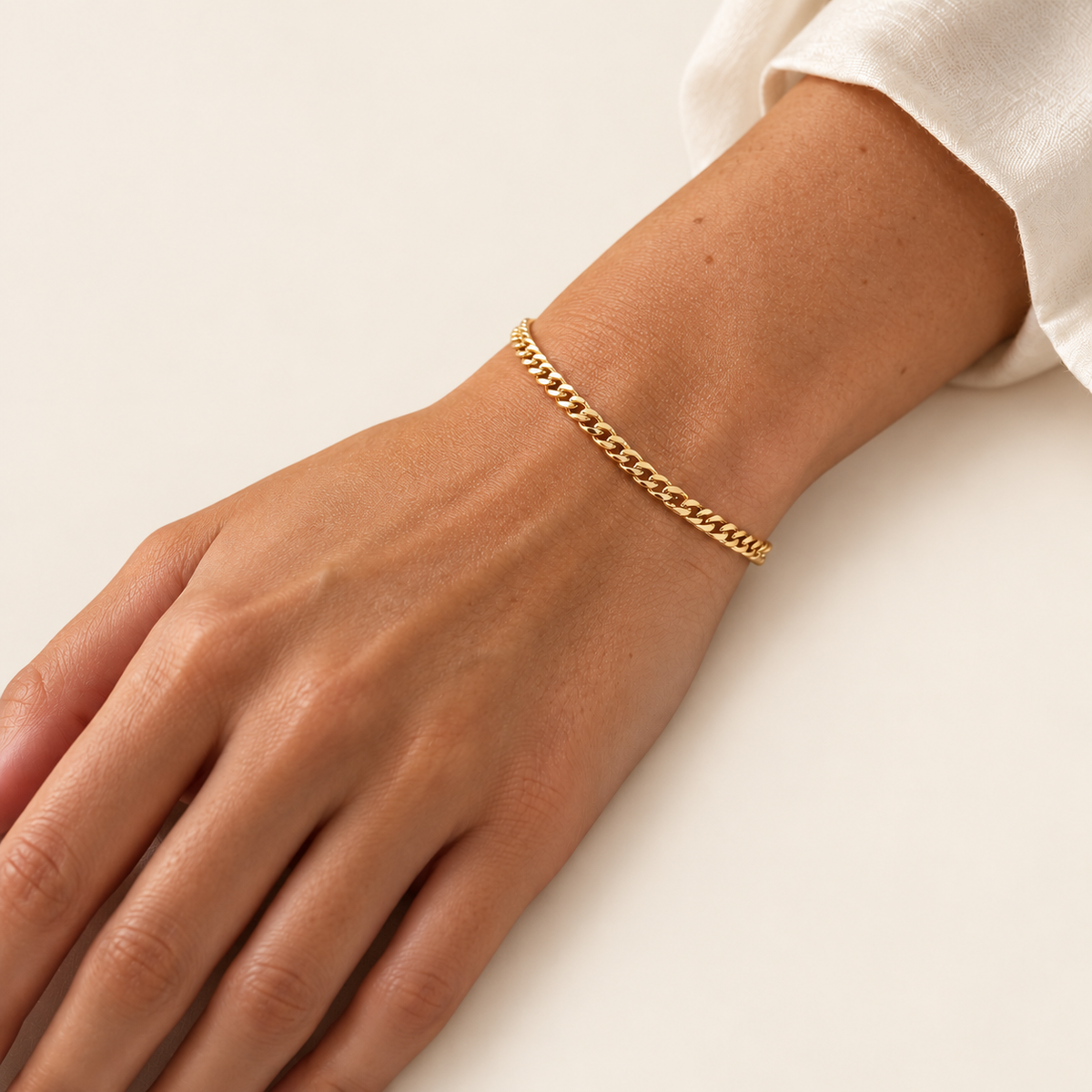 Gold Cuban Link Bracelet — warm ivory background