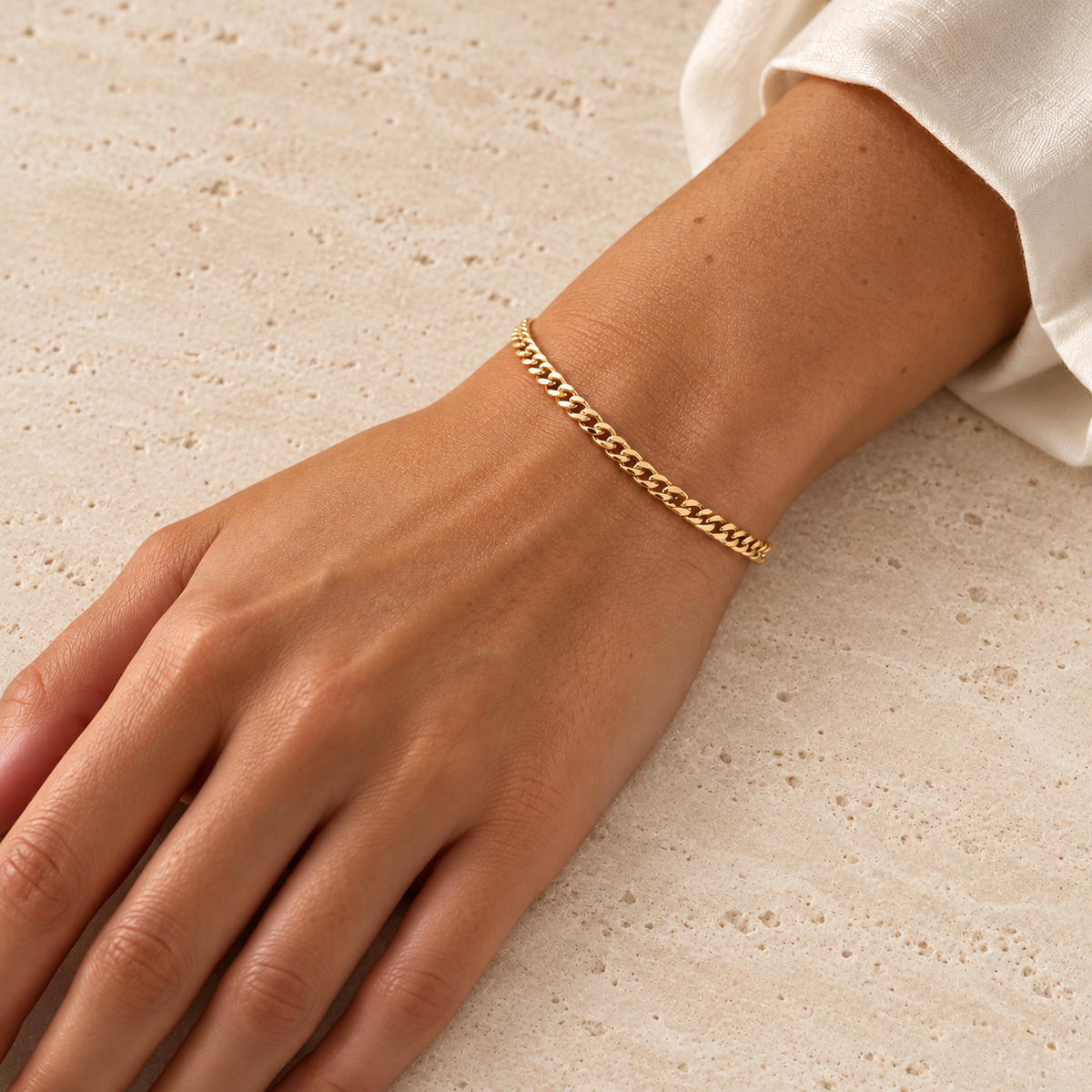Gold Cuban Link Bracelet — pale beige natural stone background