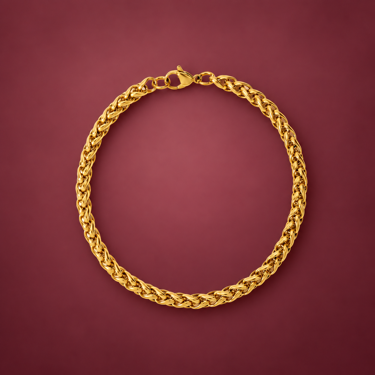 Gold-Tone Wheat Chain Bracelet — muted burgundy background