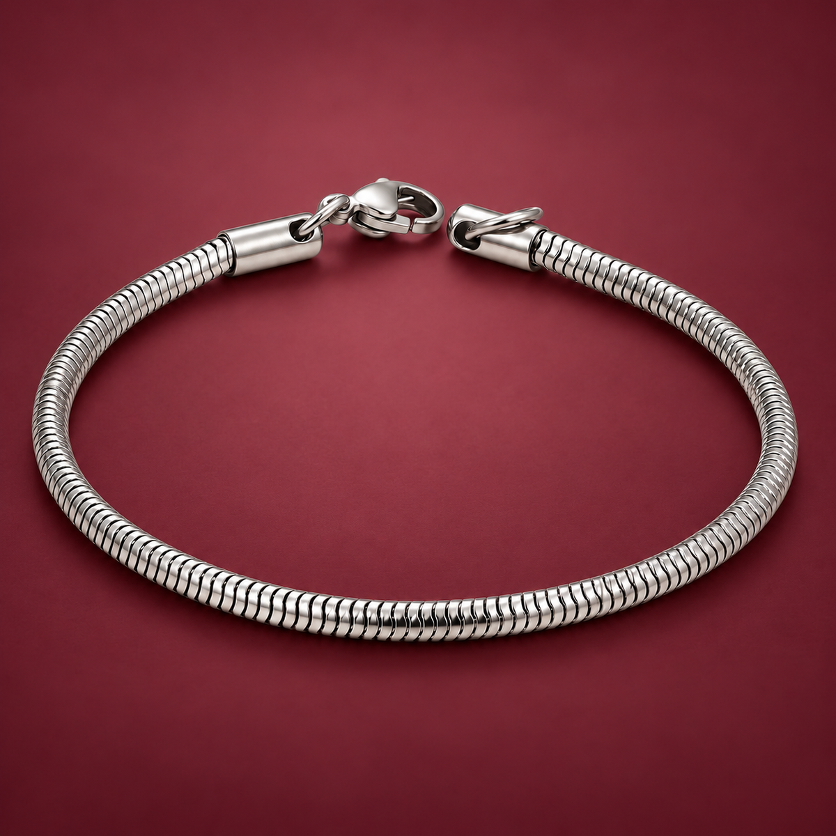Silver-Tone Snake Chain Bracelet — muted burgundy background