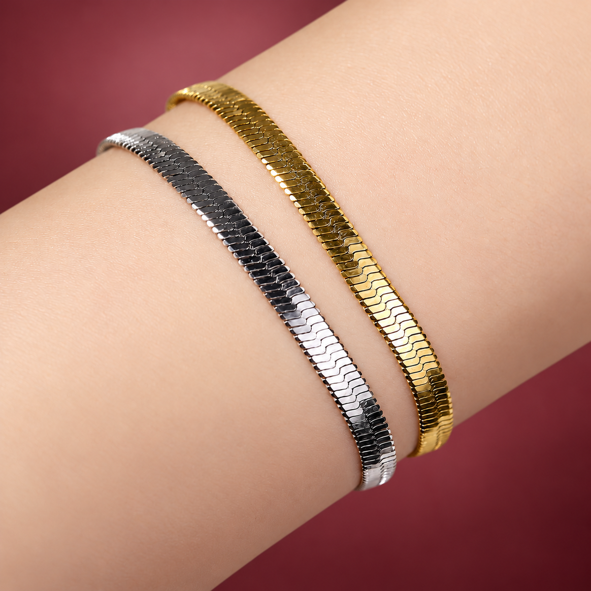 Gold-Tone Herringbone Bracelet — muted burgundy background