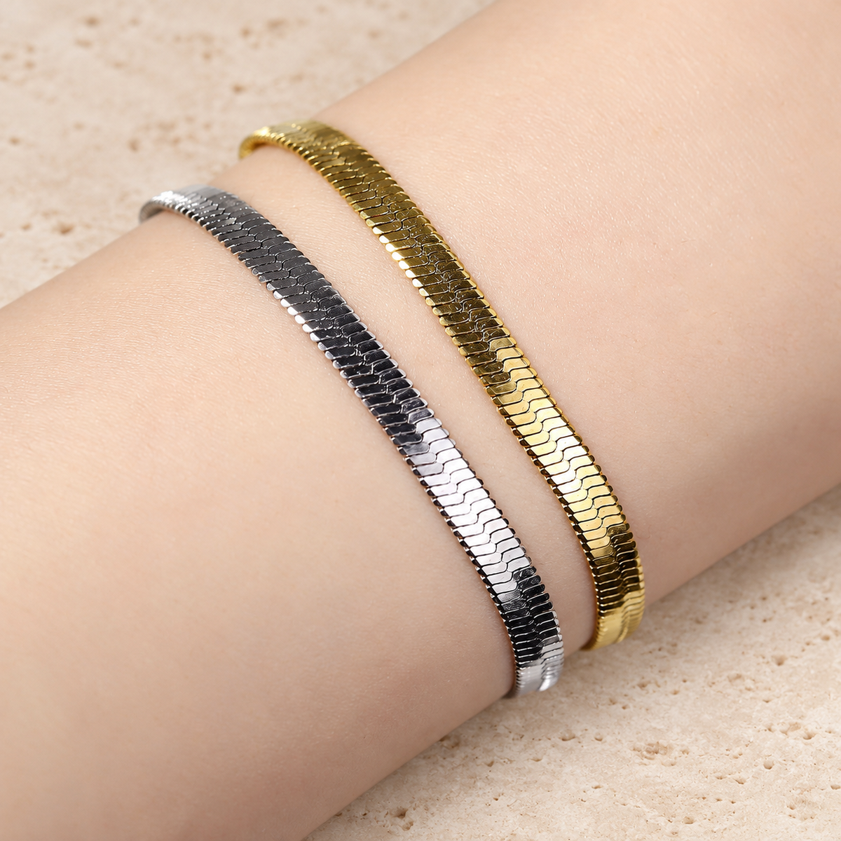 Gold Herringbone Bracelet — pale beige natural stone background