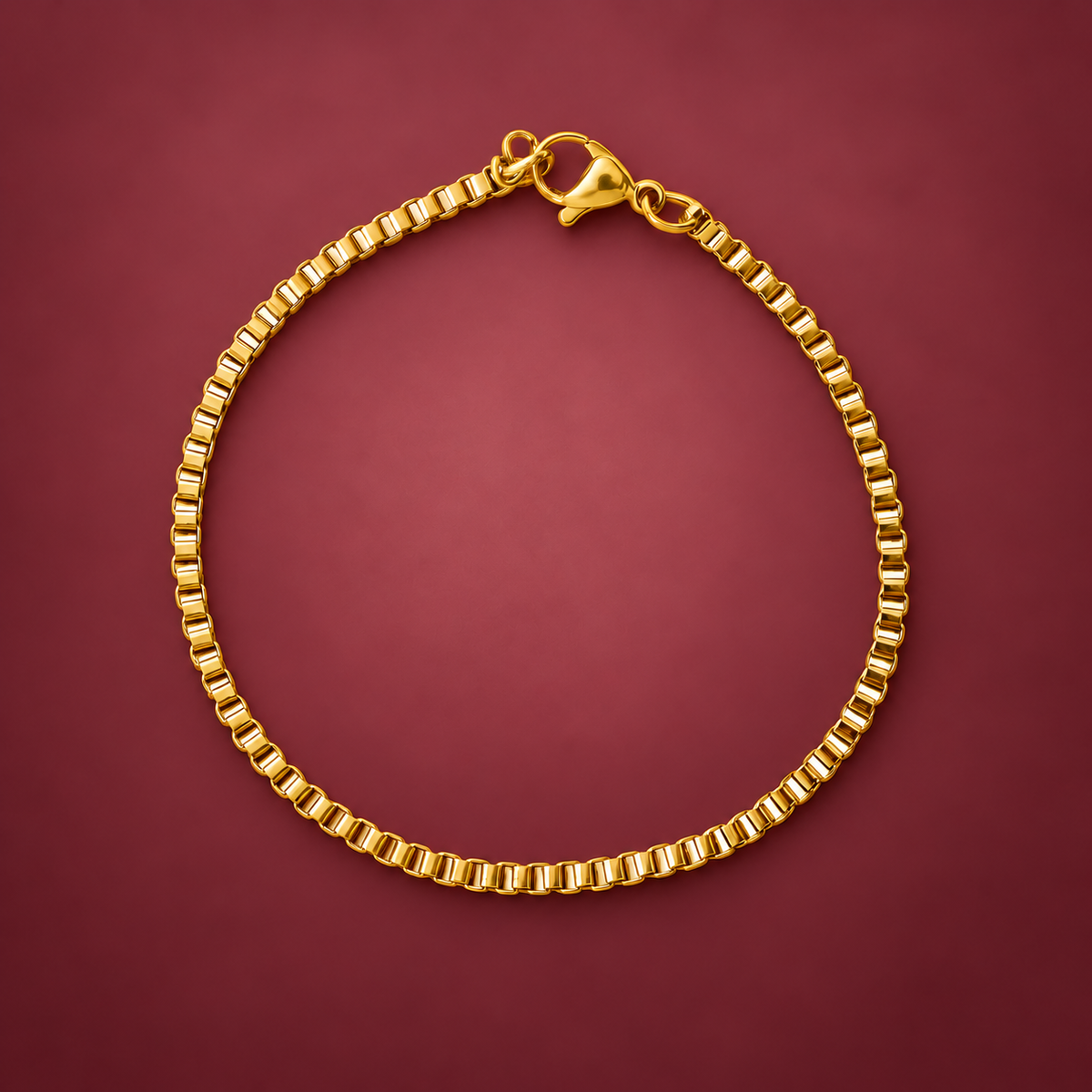 Gold-Tone Box Chain Bracelet — muted burgundy background