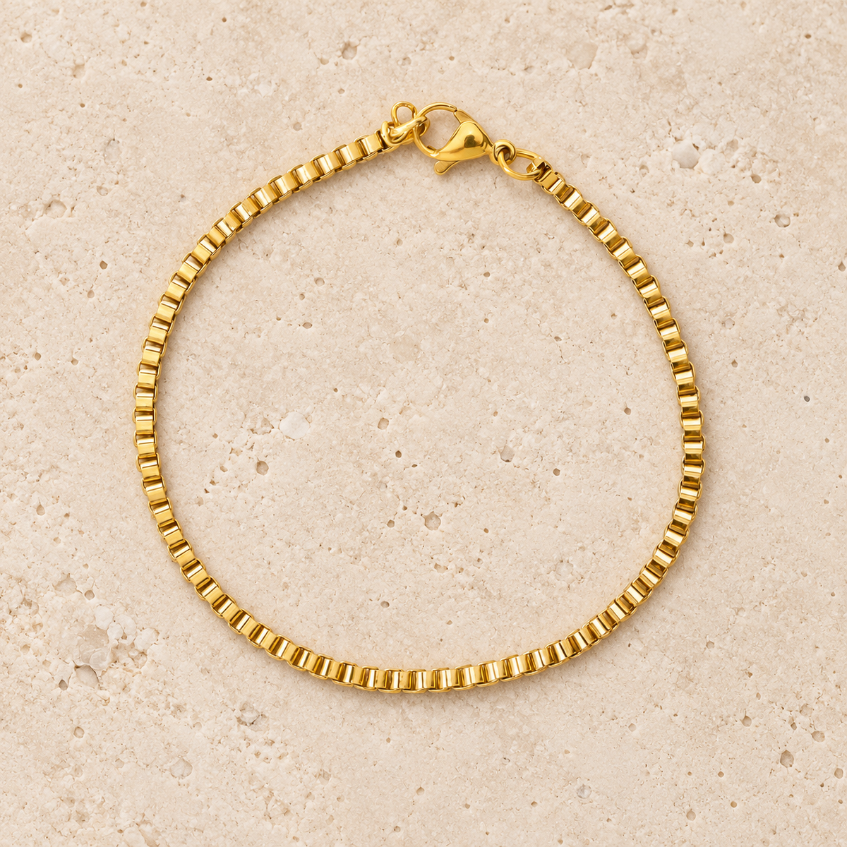 Gold Box Chain Bracelet — pale beige natural stone background