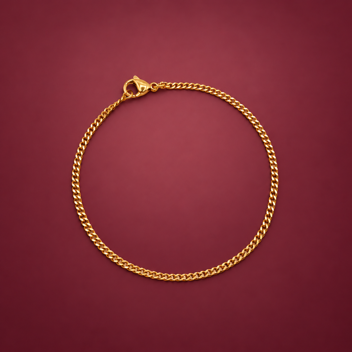 Gold-Tone Curb Bracelet — muted burgundy background