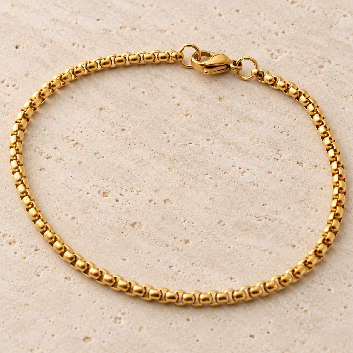 Gold Rolo Bracelet — pale beige natural stone background