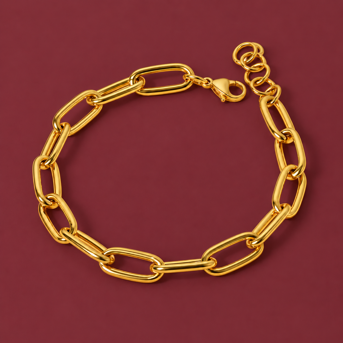 Chunky Gold-Tone Paperclip Bracelet — muted burgundy background