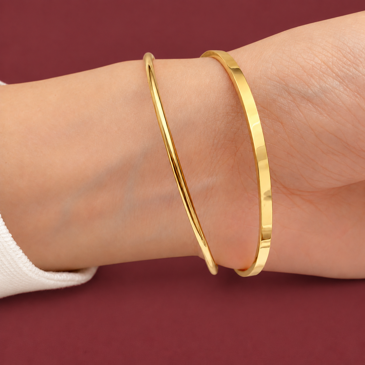 Classic Gold-Tone Bangle — muted burgundy background