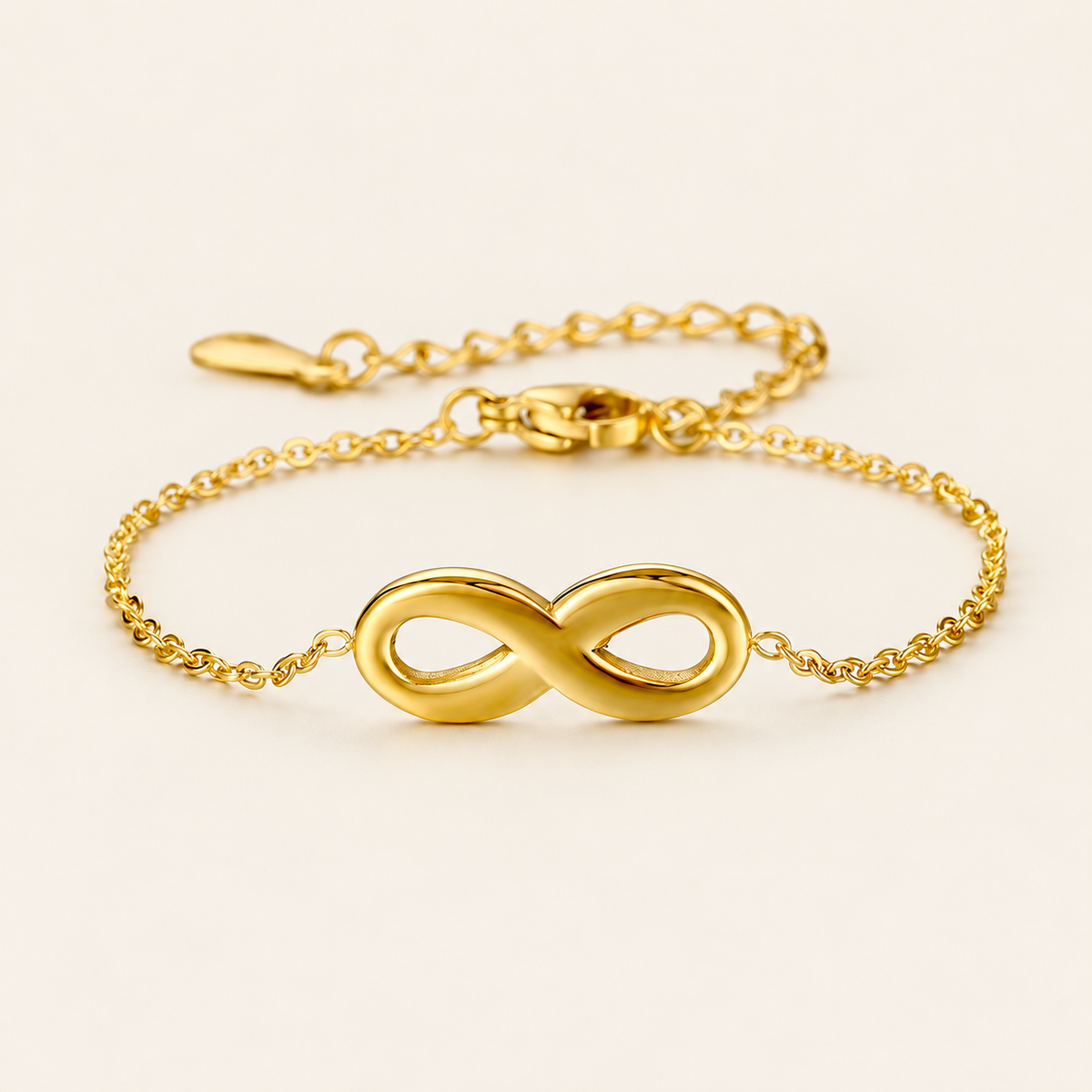Gold Infinity Bracelet — warm ivory background