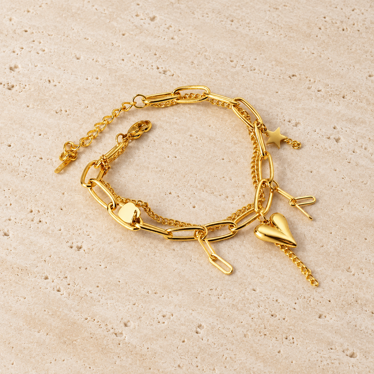 Polished Gold Charm Bracelet — pale beige natural stone background