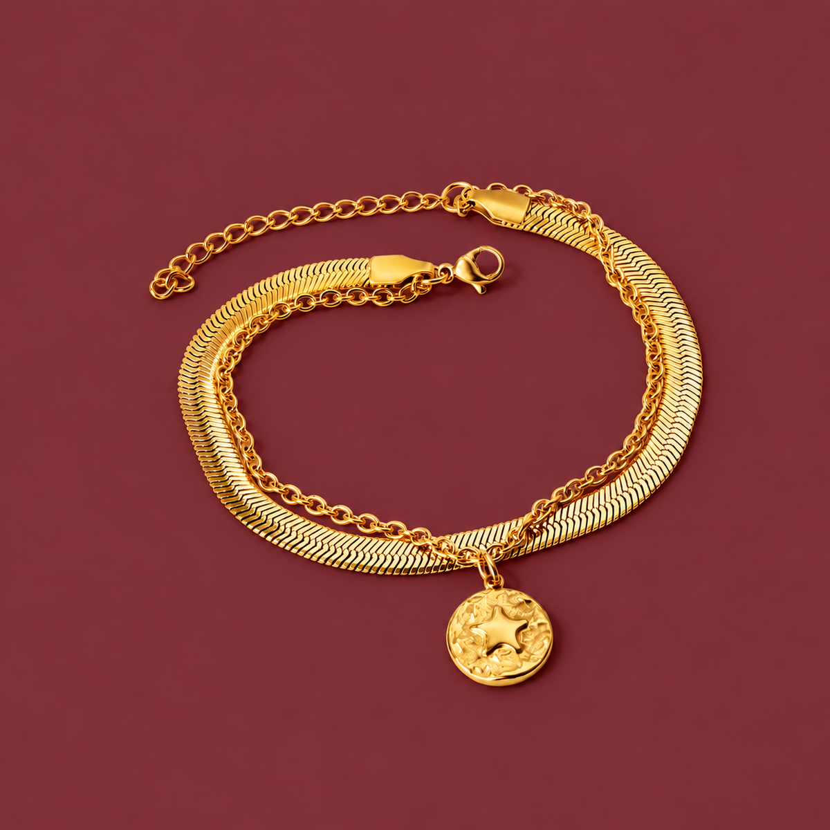 Delicate Gold-Tone Charm Bracelet — muted burgundy background