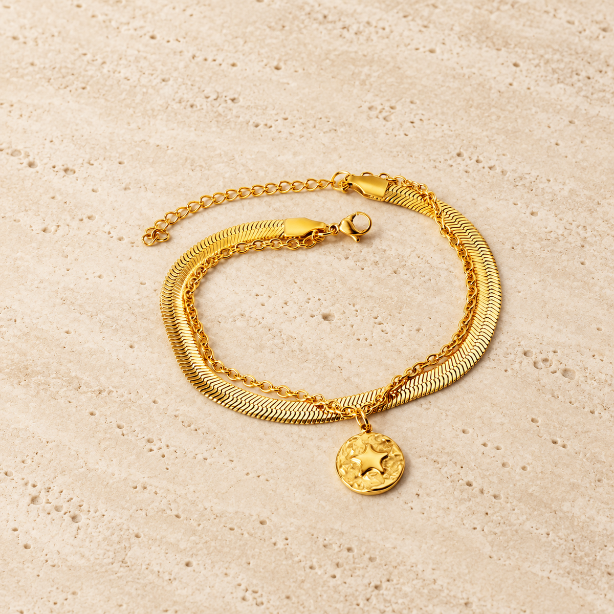 Delicate Gold Charm Bracelet — pale beige natural stone background
