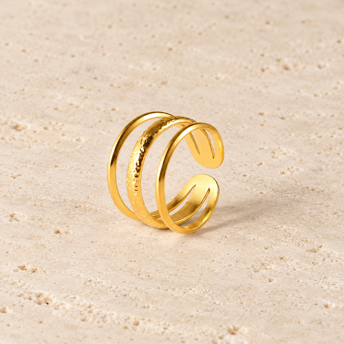 Gold Triple Line Ring — pale beige natural stone background