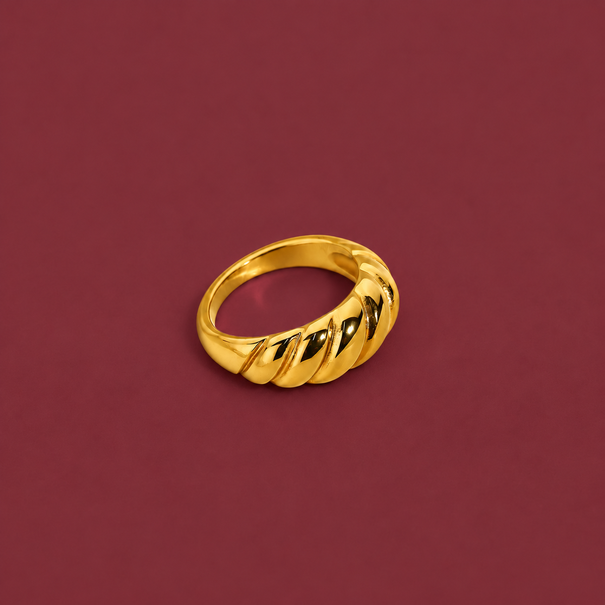 Gold-Tone Sculpted Statement Ring — muted burgundy background