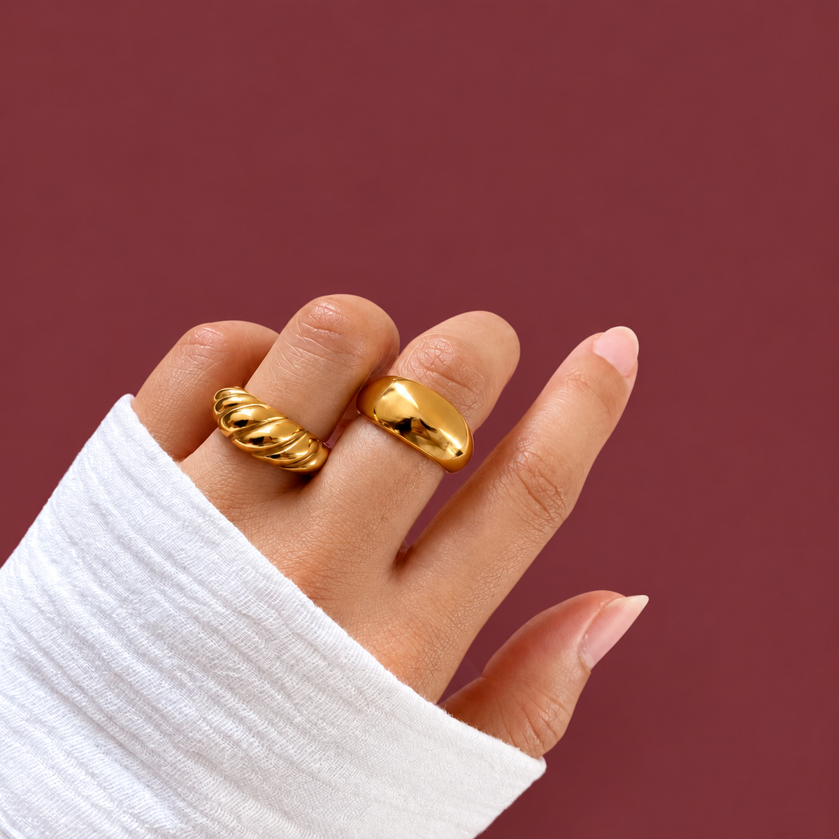 Gold-Tone Croissant Dome Ring — muted burgundy background