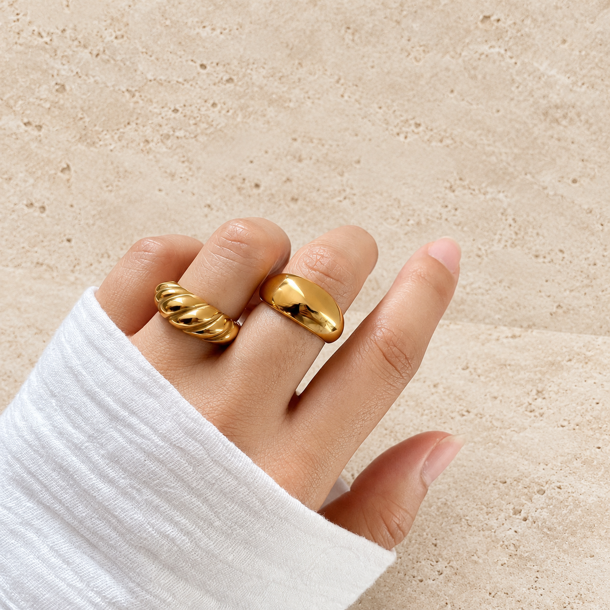 Gold Croissant Dome Ring — pale beige natural stone background