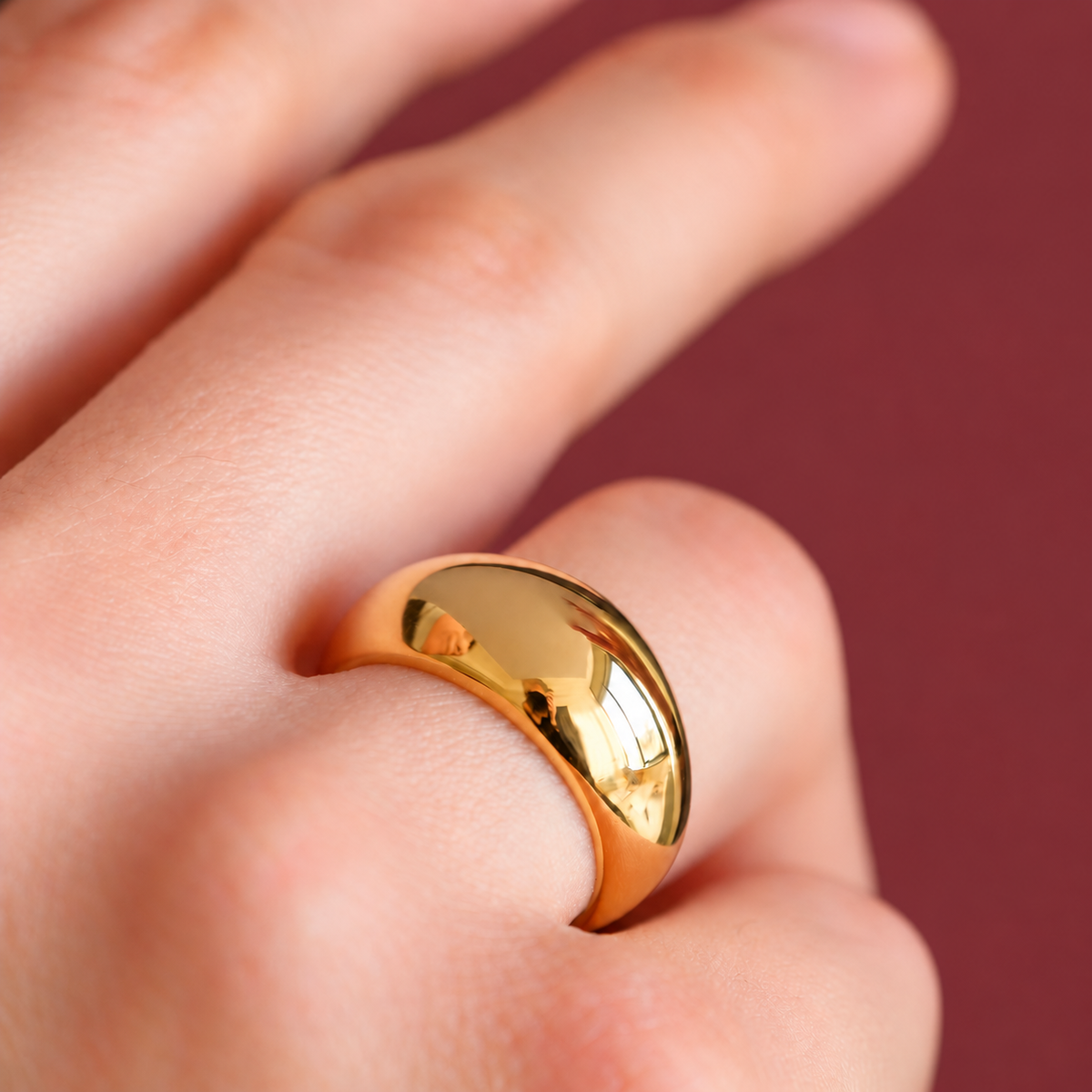 Gold-Tone Ribbed Dome Ring — muted burgundy background