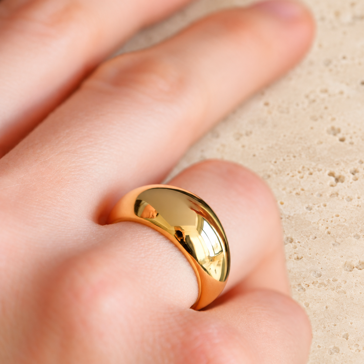 Gold Ribbed Dome Ring — pale beige natural stone background