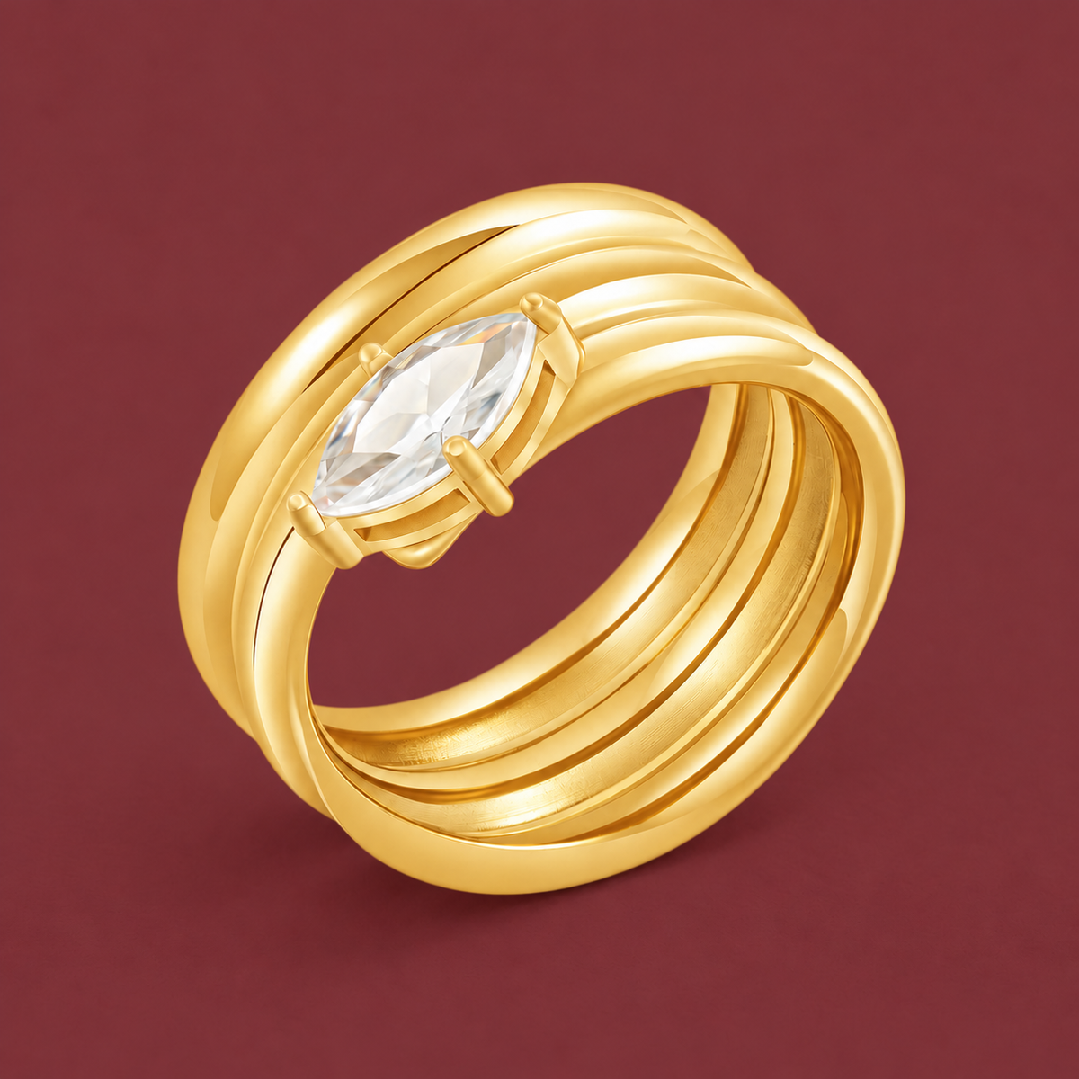Gold-Tone Oval Zircon Spiral Ring — muted burgundy background