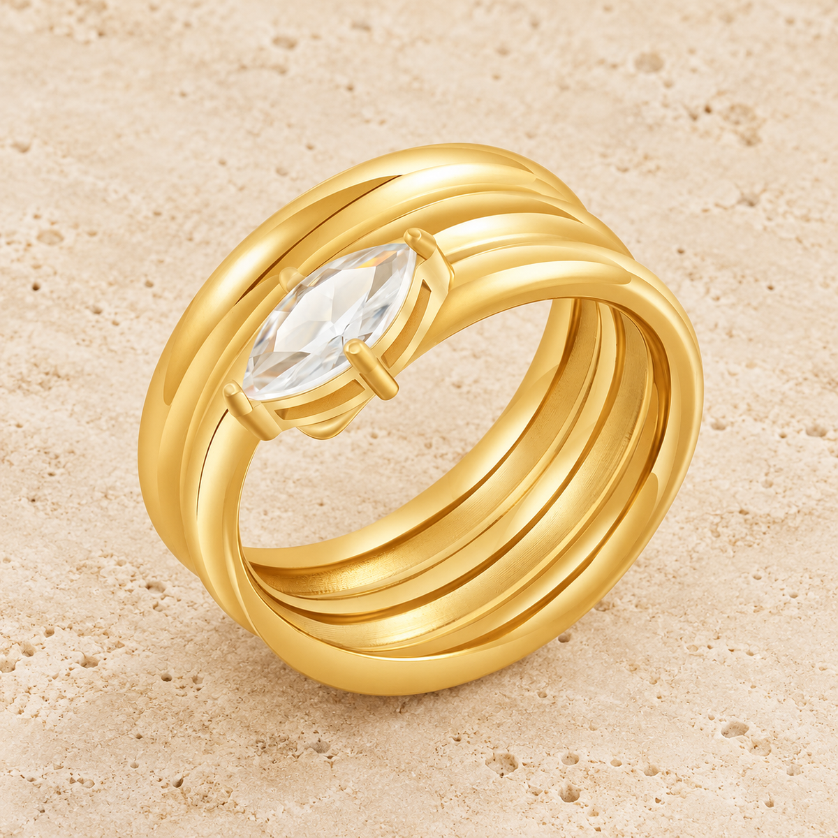 Gold Oval Zircon Spiral Ring — pale beige natural stone background