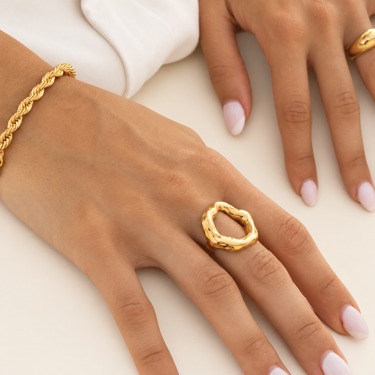 Gold Irregular Circle Ring — warm ivory background