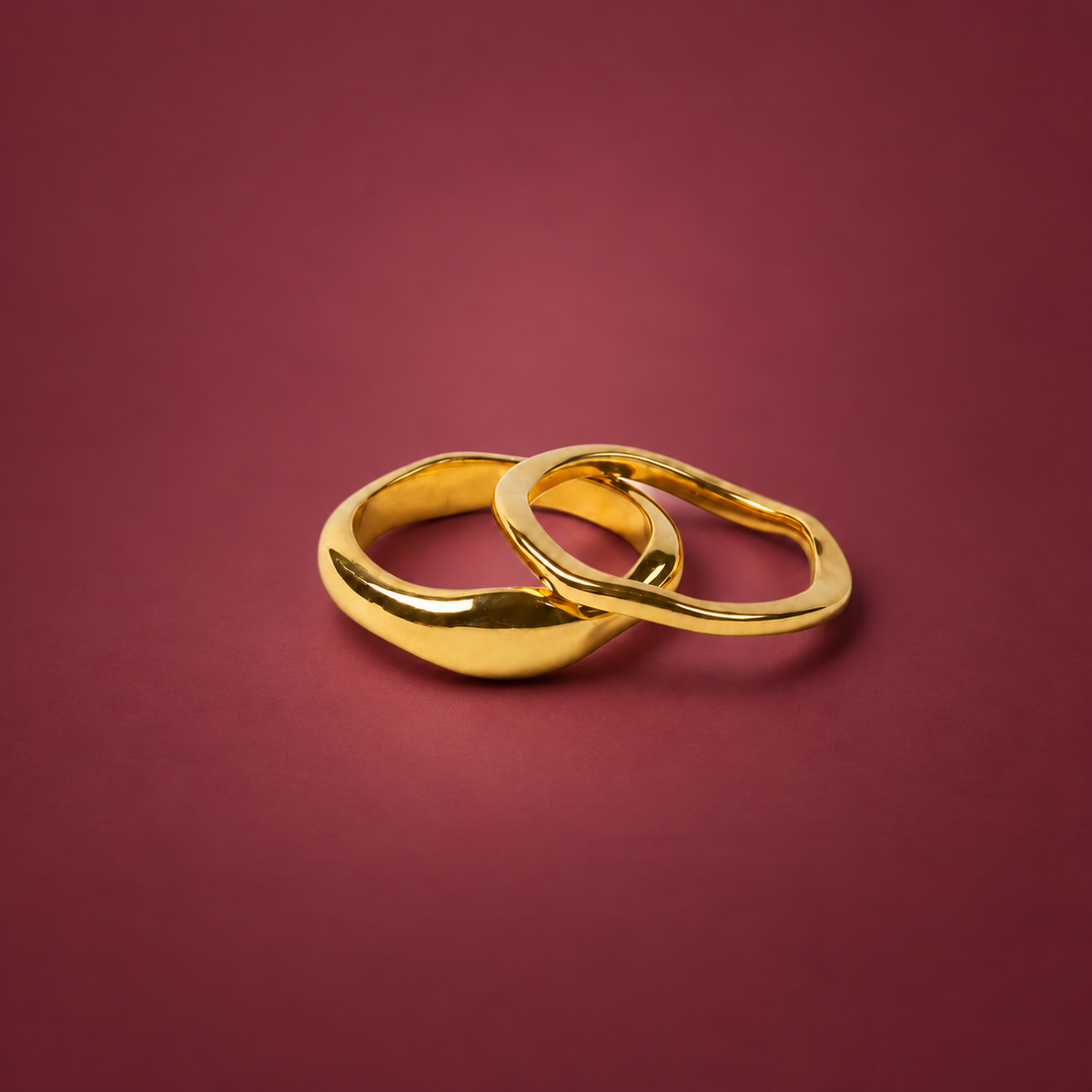 Gold-Tone Stackable Band Ring — muted burgundy background