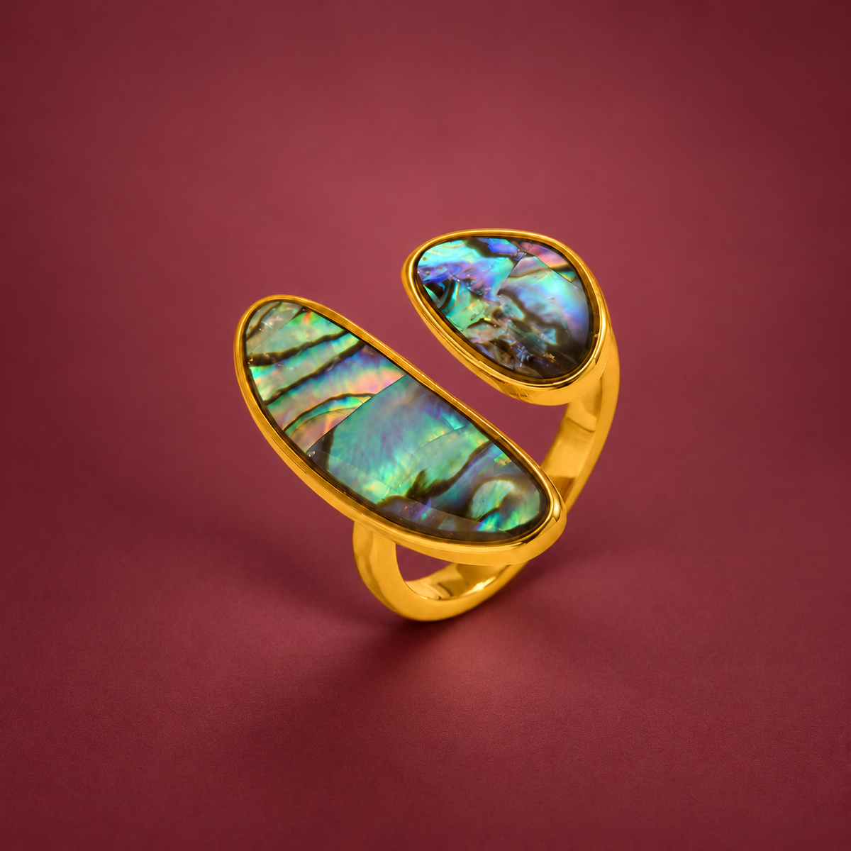 Gold-Tone Shell Ring — muted burgundy background