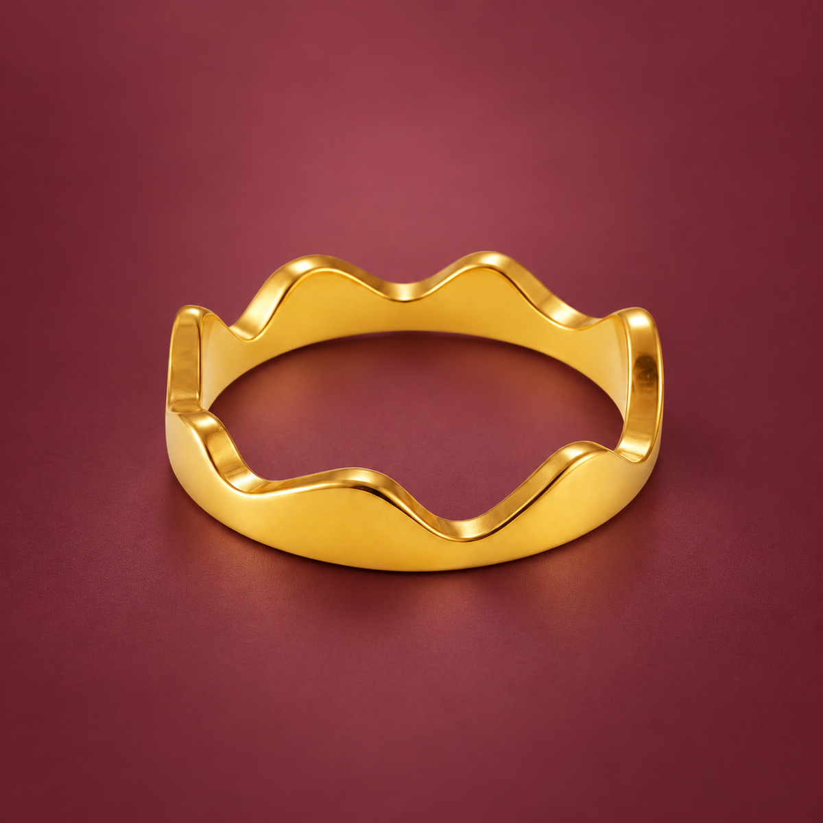 Gold-Tone Crown Wave Ring — muted burgundy background