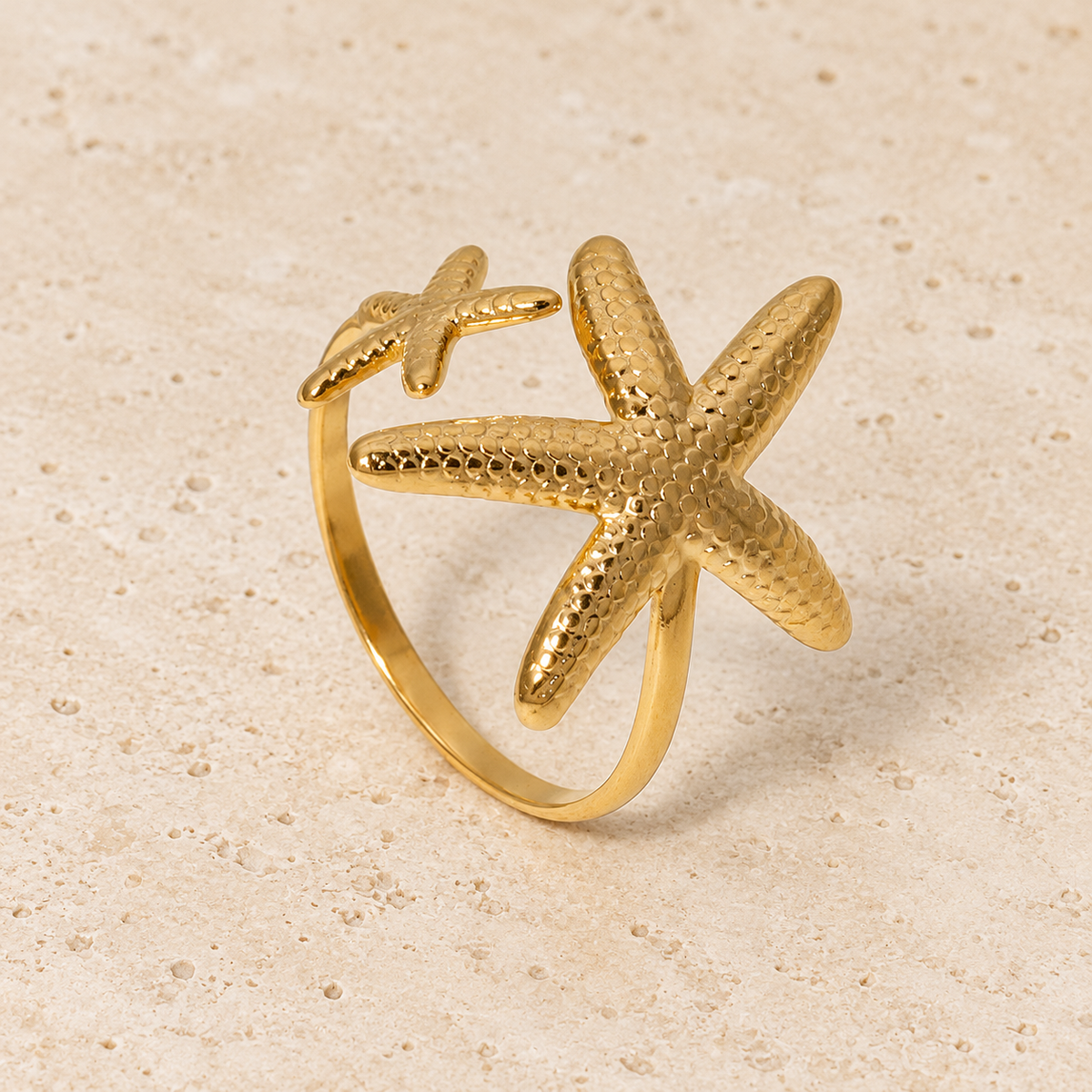 Gold Starfish Open Ring — pale beige natural stone background