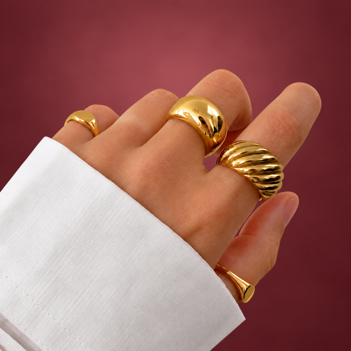 Twisted Croissant Dome Ring — muted burgundy background