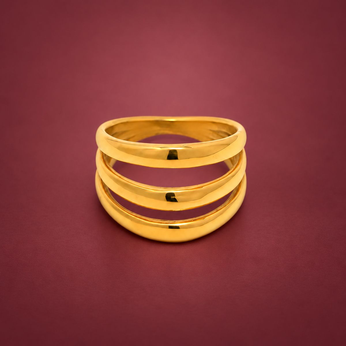 Triple Wave Statement Ring — muted burgundy background