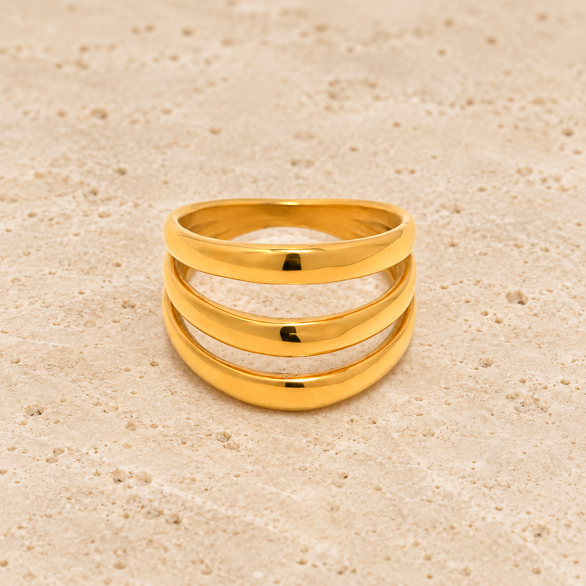 Triple Wave Statement Ring — pale beige natural stone background