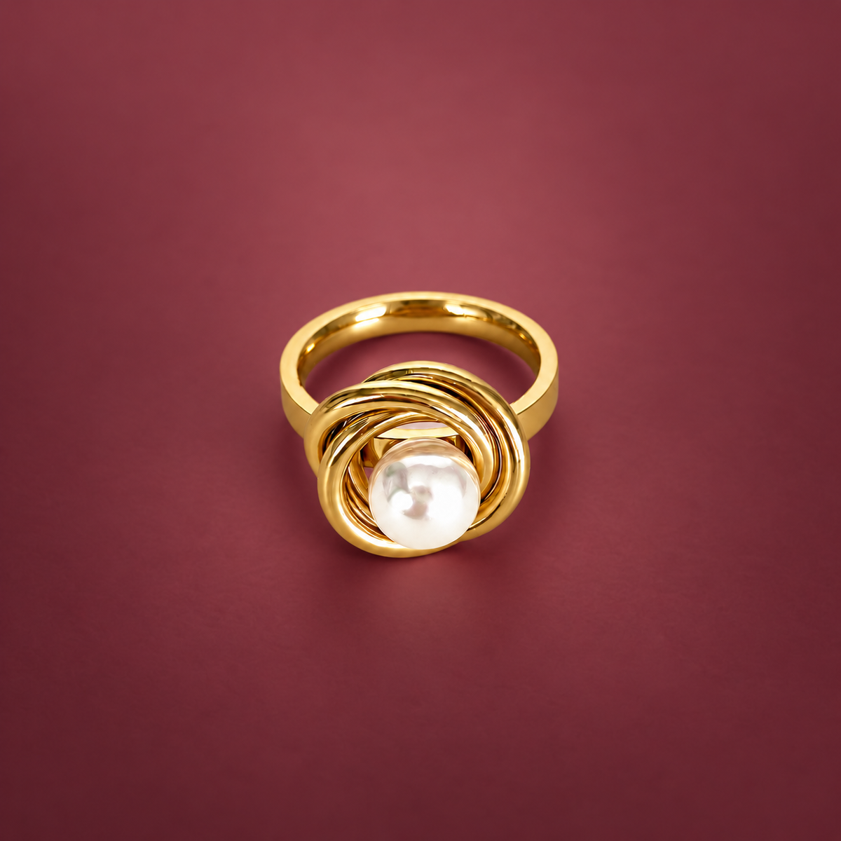 Pearl Spiral Ring — muted burgundy background