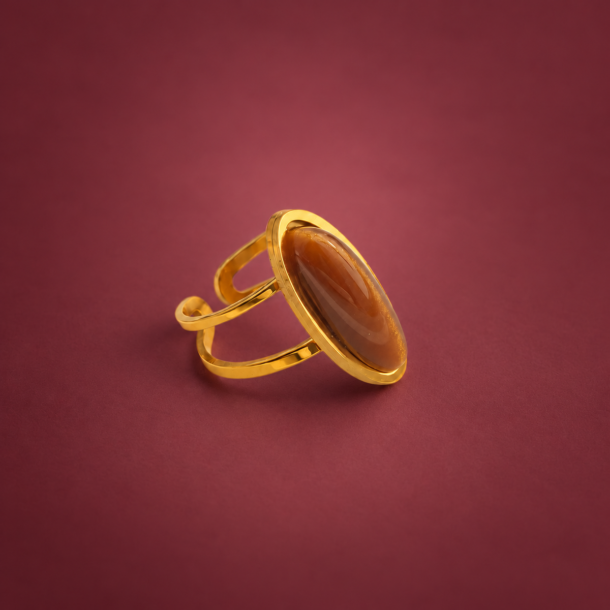 Oval Amber Ring — muted burgundy background
