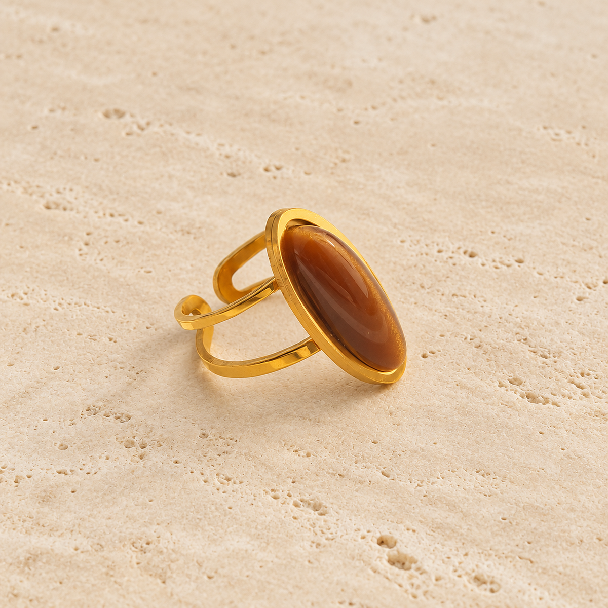 Oval Amber Ring — pale beige natural stone background